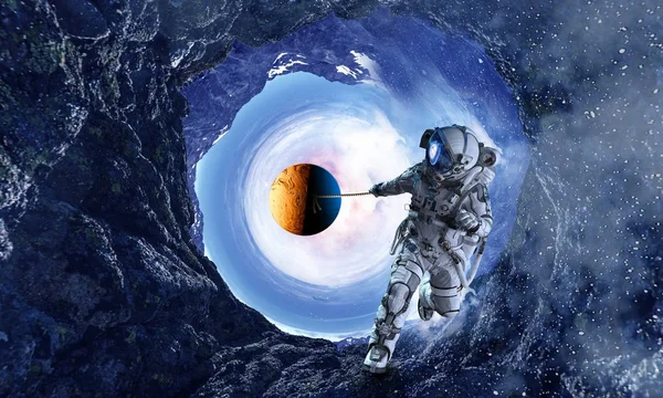 Fantasy image with spaceman catch planet. Mixed media — Stock Photo, Image