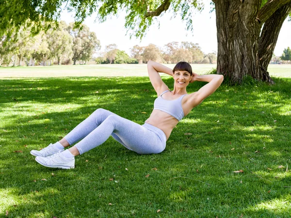 Jeune femme faisant de l'exercice dans le parc — Photo