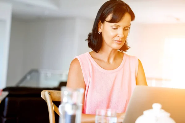 Pretty woman working on her laptop — Stock Photo, Image