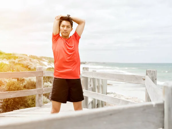 Young man doing exercise at the beach — Stock Photo, Image
