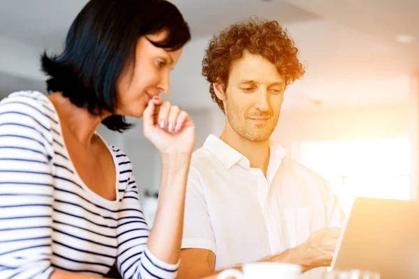 Happy modern couple working on laptop at home — Stock Photo, Image