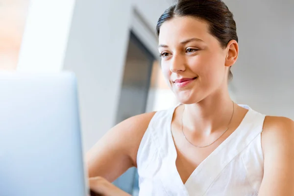 Jovem mulher bonita trabalhando em seu laptop — Fotografia de Stock