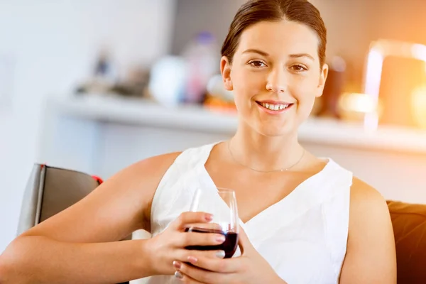 Beautiful young woman holding glass with red wine — Stock Photo, Image