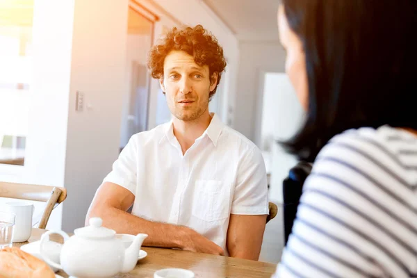 Portret van man zitten en praten met de vrouw binnenshuis — Stockfoto