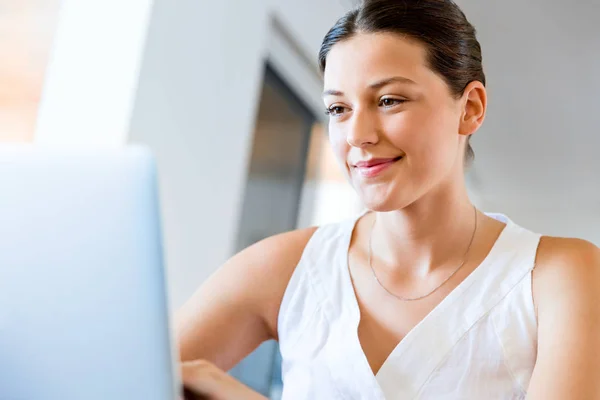Young beautiful woman working on her laptop Stock Image
