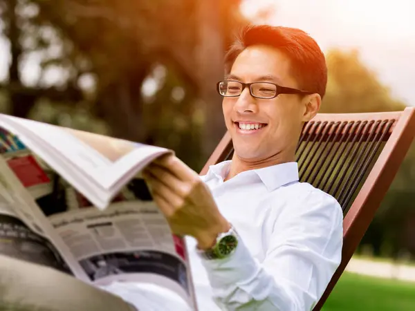 Young happy and successful businessman during his break in park — Stock Photo, Image