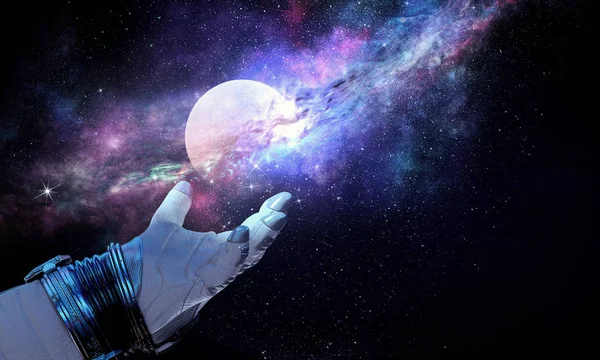 Moon planet in spaceman hand. Mixed media — Stock Photo, Image