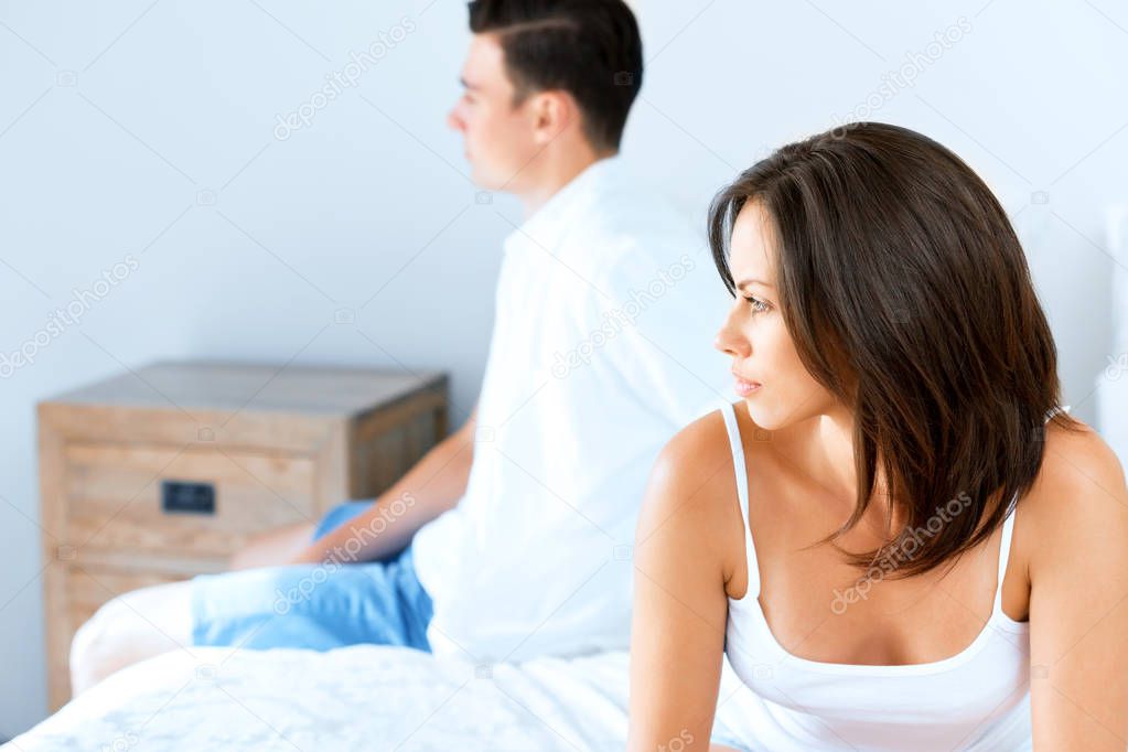 Couple in stress sitting on the bed