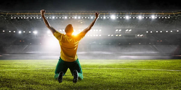 Soccer player at stadium. Mixed media