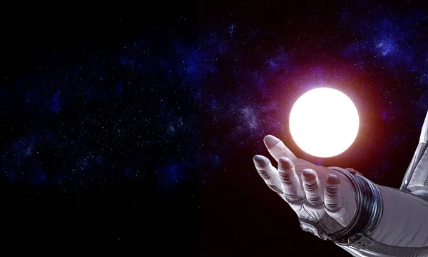 Moon planet in spaceman hand. Mixed media — Stock Photo, Image