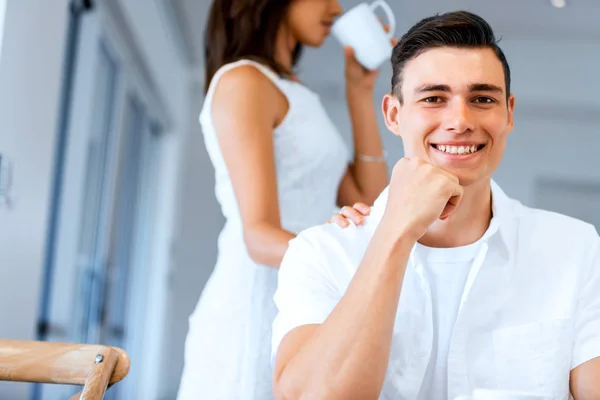 Happy young man with cup of tea or coffee — Stock Photo, Image