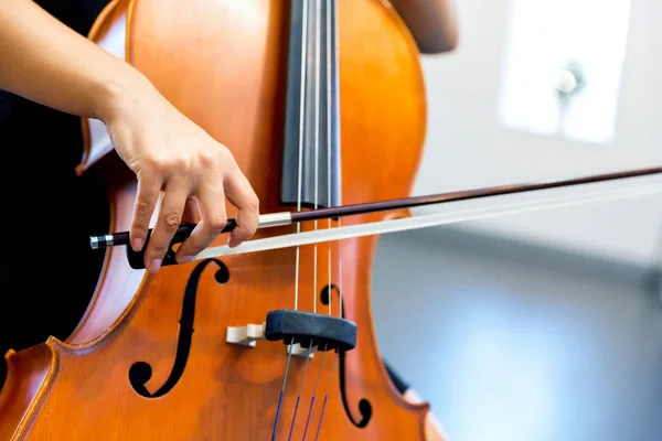 Close up of cello with bow in hands — Stock Photo, Image