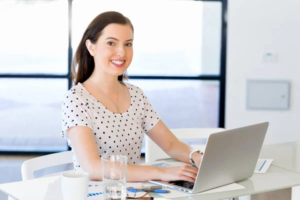 Portrait of businesswoman working at computer in office — Stock Photo, Image