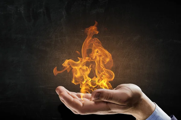 Fire burning in his hands — Stock Photo, Image