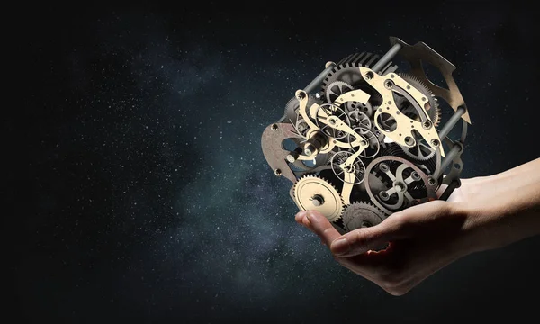 Ozubenou mechanismus v ruce. Kombinovaná technika — Stock fotografie