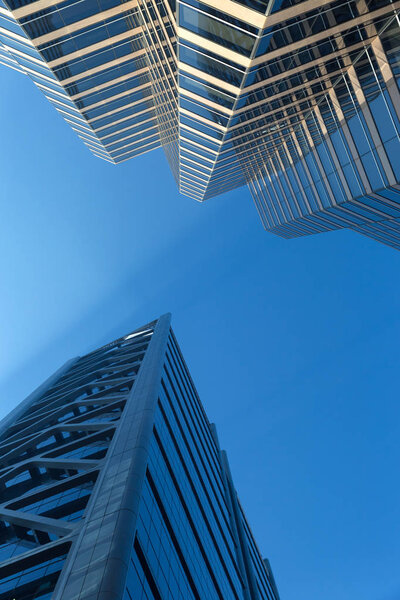 Low angle shot of modern glass city buildings