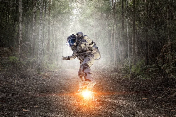 Spaceman on flying board. Mixed media — Stock Photo, Image