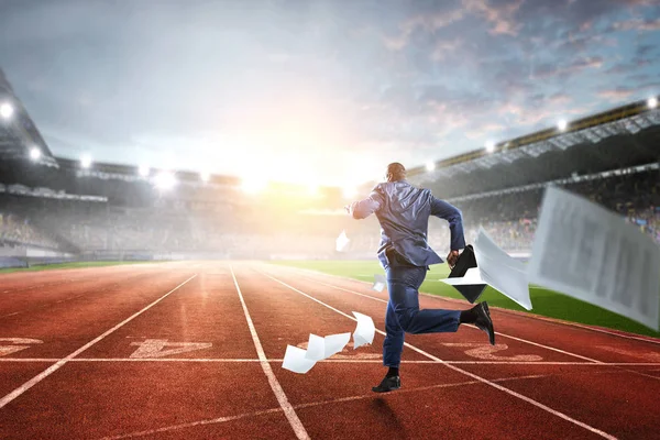 Businessman running in a hurry. Mixed meia — Stock Photo, Image