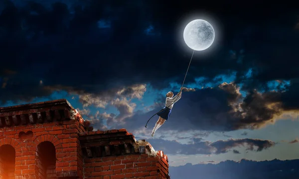 A kislány elkapja a holdat. Vegyes média — Stock Fotó