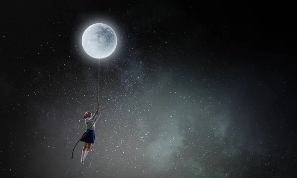 Kid girl catching moon. Mixed media — Stock Photo, Image