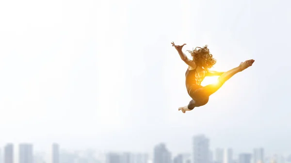 Gymnast girl in jump Смешанные медиа — стоковое фото