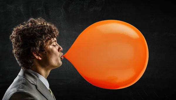 Guy blowing bubble . Mixed media — Stock Photo, Image