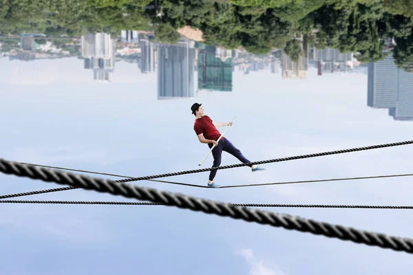 Brave ropewalker on cable. Mixed media — Stock Photo, Image