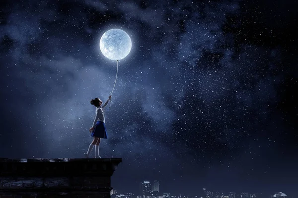 Kid girl catching moon. Mixed media — Stock Photo, Image