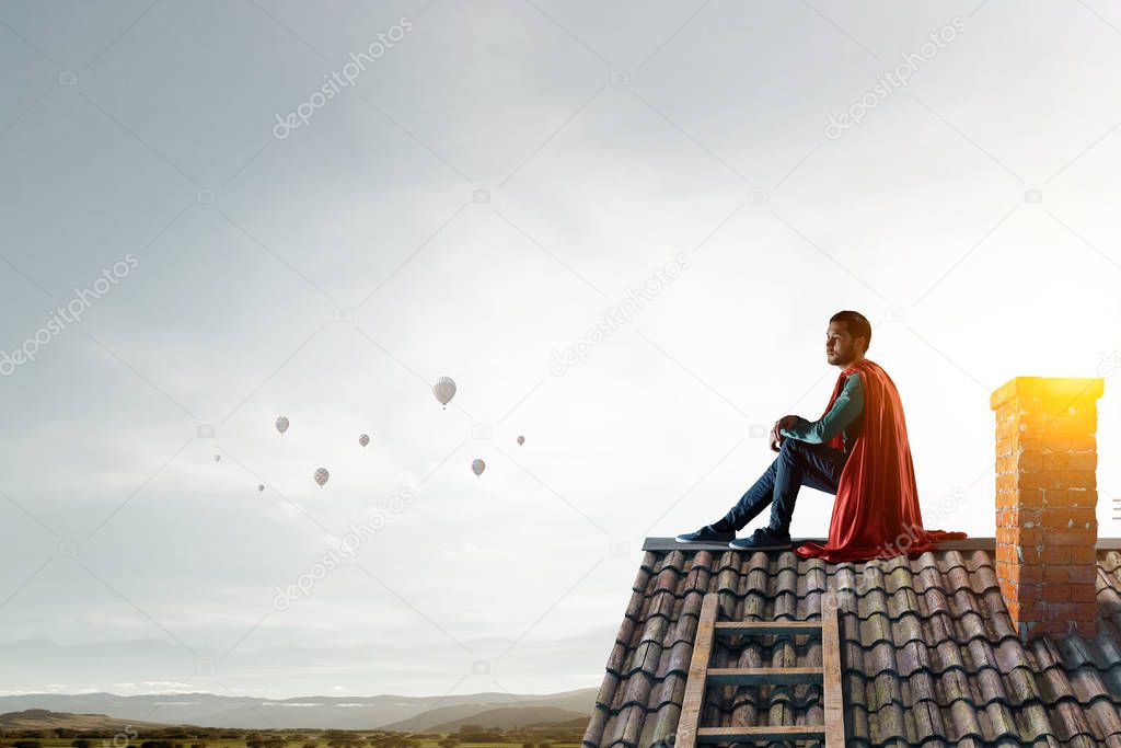 Super hero on roof. Mixed media