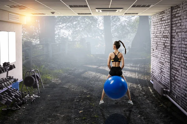 Mujer deportiva en la pelota de fitness. Medios mixtos — Foto de Stock