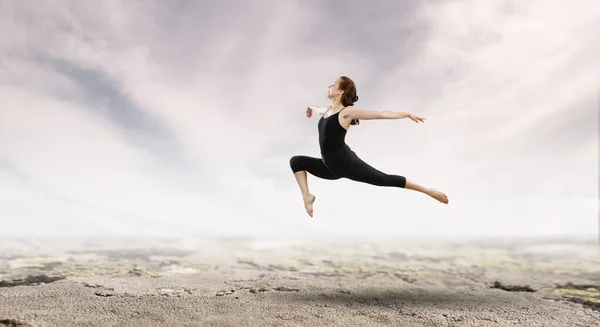 Gymnast girl in jump Mixed media — Stock Photo, Image