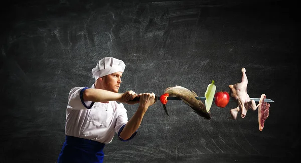 He is crazy about cooking. Mixed media — Stock Photo, Image