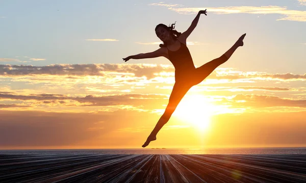 Gymnast girl in jump Смешанные медиа — стоковое фото