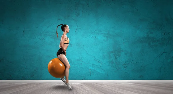 Sporty woman on fitness ball. Mixed media — Stock Photo, Image