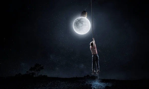 Kid boy catching moon. Mixed media — Stock Photo, Image