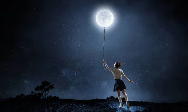 Kid girl catching moon. Mixed media — Stock Photo, Image