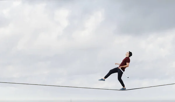 Brave ropewalker on cable. Mixed media — Stock Photo, Image