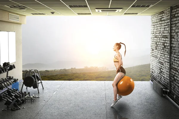 Sporty woman on fitness ball. Mixed media — Stock Photo, Image