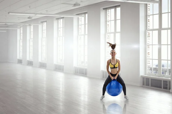 Sporty woman on fitness ball. Mixed media — Stock Photo, Image