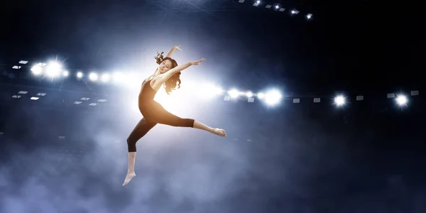 Gymnast girl in jump Смешанные медиа — стоковое фото