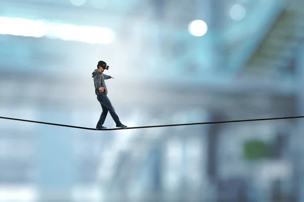 Man wearing virtual reality goggles and balancing on rope — Stock Photo, Image