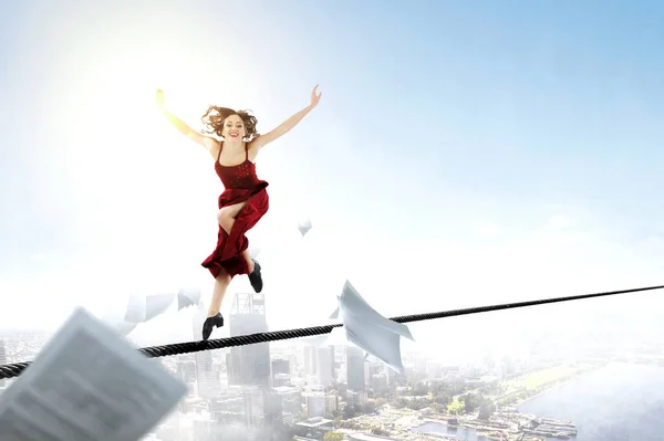 Young and beautiful female dancer in a red dress jumping — Stock Photo, Image