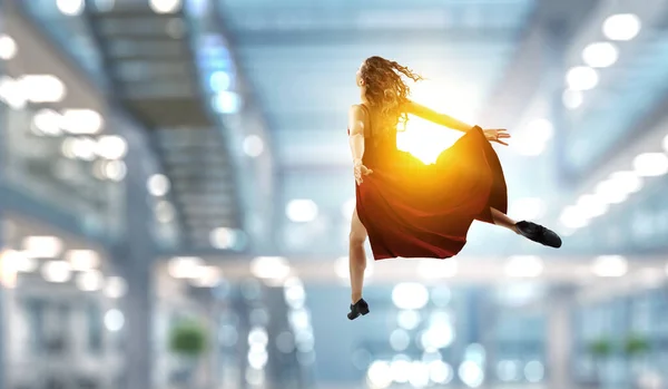 Young and beautiful female dancer in a red dress — Stock Photo, Image