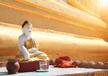 Old stone statue of meditating Buddha, Bago, Myanmar  clipart