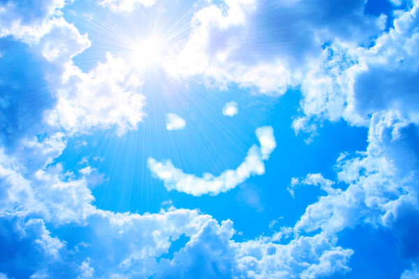 Smilie from cloud and bright sun in blue sky 