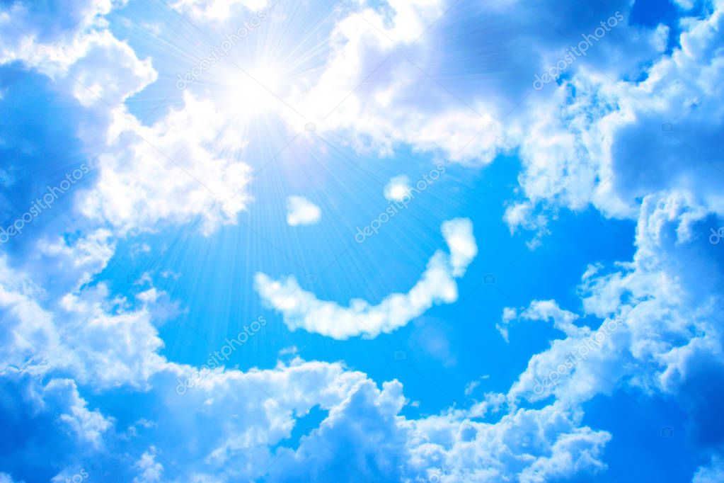 Smilie from cloud and bright sun in blue sky 