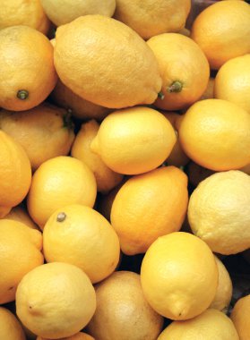 Ripe lemons in supermarket clipart