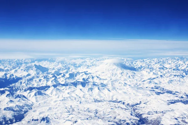 Aerial view from the aircraft to Caucasus Mountains covered with — Stock Photo, Image