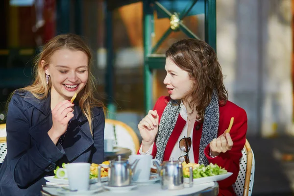 Twee jonge meisjes in de Parijse outdoor cafe — Stockfoto