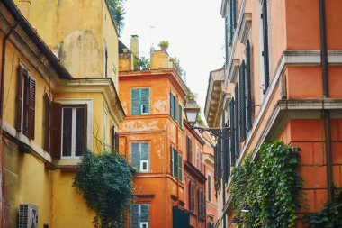 Colorful yellow and orange buildings on a street of Rome clipart